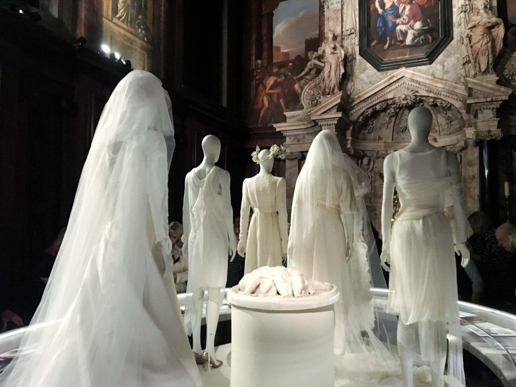 The rear view of a display of some 5 wedding dresses on mannequins in the Chatsworth Chapel