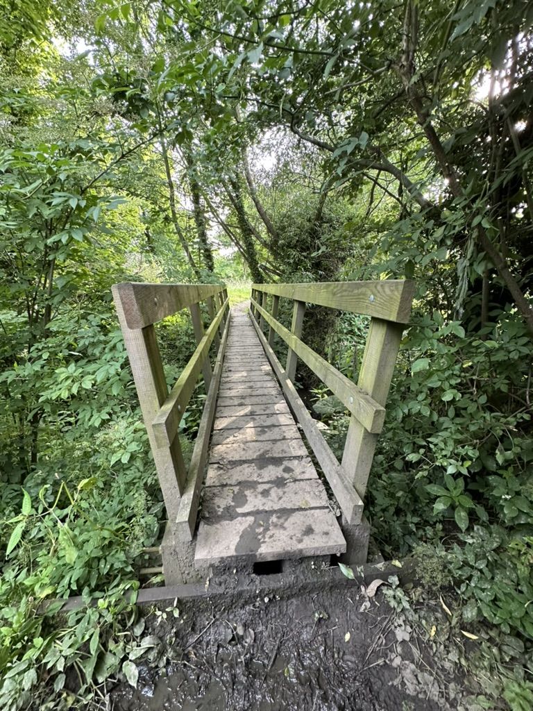 Narrow wooden foot bridge over the River Derwent on Walk 1 of our Walks Around Darley Dale